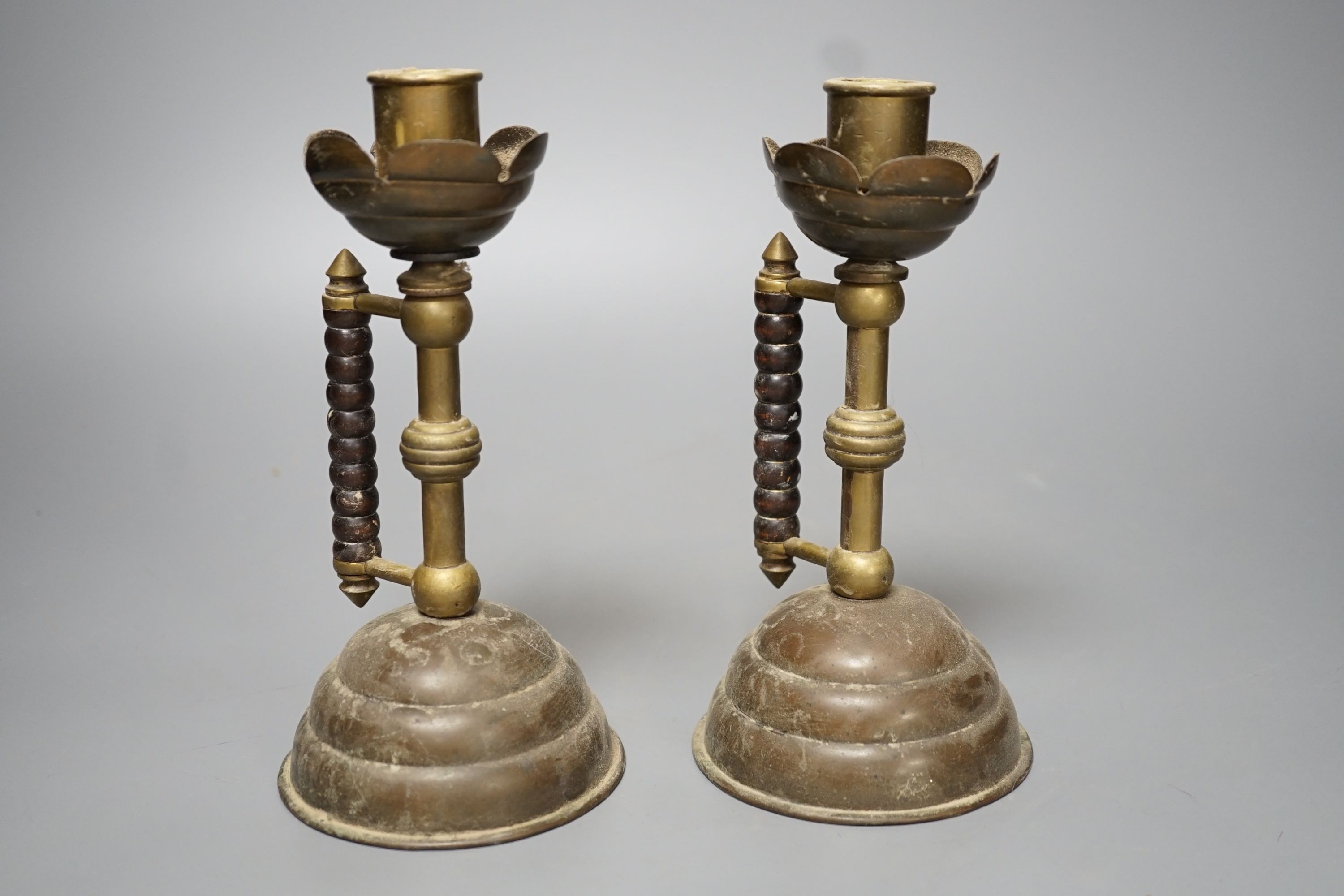 A pair of Gothic brass stem cup and handled candlesticks - 19.5cm high